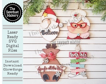 May include: Set of five laser-cut wooden Christmas ornaments featuring Santa, Mrs. Claus, a reindeer, a sign that says "Believe", and a sign that says "North Pole" with directional signs that say "Santa's Workshop", "Reindeer Games", and "Elf Village".