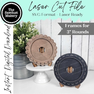 May include: Two laser cut frames for 3 inch round items. One frame is brown with a scalloped edge and the other is black with a scalloped edge. Both frames are on small wooden stands.