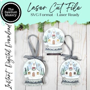 May include: Laser cut file of three wooden Christmas ornaments shaped like snow globes, each featuring a church scene with a red bow and the text "Peace on Earth." The ornaments have black and white checkered ribbon hangers.