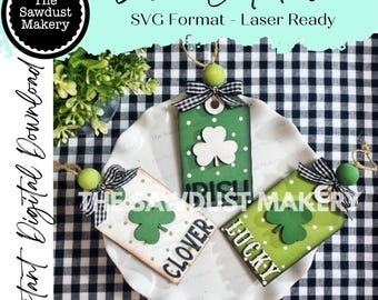 May include: Three laser cut wooden tags with green shamrock designs and white polka dots. The tags are labeled "Irish", "Clover", and "Lucky".