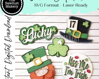 May include: A set of five laser cut SVG files for a St. Patrick's Day themed craft project. The files include a leprechaun hat, a shamrock, a leprechaun face, a sign that says "Kiss Me I'm Irish", and a sign that says "Lucky".
