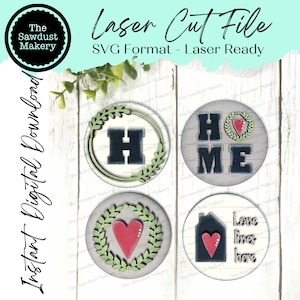 May include: Four laser cut SVG files for crafting. The designs include a wreath with the letter H, a wreath with a heart, the word HOME with a wreath and heart, and a house with a heart and the text "Love lives here".
