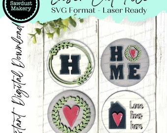 May include: Four laser cut SVG files for crafting. The designs include a wreath with the letter H, a wreath with a heart, the word HOME with a wreath and heart, and a house with a heart and the text "Love lives here".