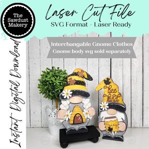 May include: Two wooden gnome figures with bee-themed hats and details. One gnome holds a beehive, the other a honey jar. The text "Bee Kind" and "Honey" are visible. The image also includes text that says "Laser Cut File" and "Instant Digital Download".