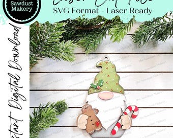 May include: A laser cut file for a Christmas gnome ornament. The gnome is holding a gingerbread man and a candy cane. The file is in SVG format and is laser ready.