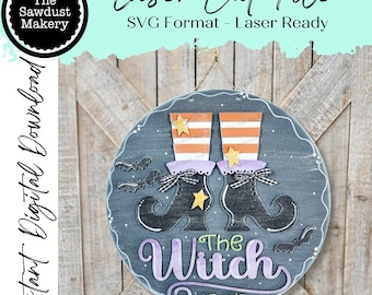 May include: A round, gray wooden sign with a Halloween theme. It features witch boots, bats, and the phrase "The Witch is In." The boots have orange and white striped tops and are adorned with stars. The sign is a laser cut file.