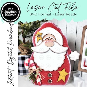 May include: A red and white Santa Claus-shaped laser cut file. The design includes a white beard, a red hat, and a candy cane. The text "Laser Cut File" and "SVG Format - Laser Ready" are visible. The words "Instant Digital Download" are also present.