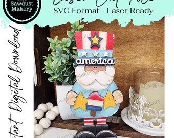 May include: A wooden figurine of Uncle Sam holding an ice lolly. He is wearing a red, white and blue hat with stars and a blue shirt with the word "america" on it. He is standing on a wooden base.