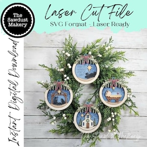 May include: Four circular wooden ornaments featuring laser-cut designs of a nativity scene, a church, a manger, and a star with the text Star of wonder star of light. Each ornament is topped with a decorative bow and hangs from a green wreath.