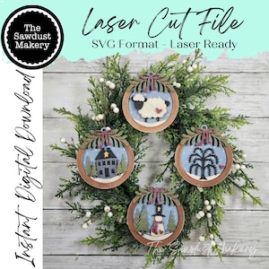 May include: Four circular wooden ornaments featuring laser-cut designs: a sheep with a heart, a house with a star, a willow tree, and a snowman. Each ornament has a decorative bow at the top. Text includes Laser Cut File, SVG Format, and The Sawdust Makery.