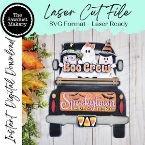May include: A laser-cut Halloween decoration featuring a black truck with the words "Boo Crew" and "Spookytown" on it. The truck bed holds three ghost figures. The design includes bats, candy corn, and the text "Laser Cut File".