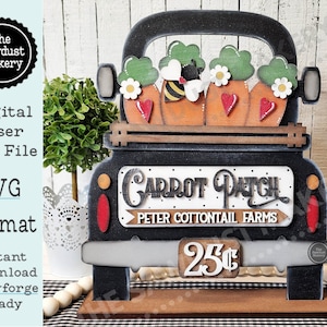 May include: A black wooden truck with a white sign that reads "Carrot Patch Peter Cottontail Farms" and a price tag that says "25c". The truck bed is filled with three orange carrots with green tops and a bee.