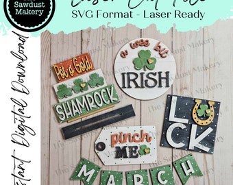 May include: A set of five laser cut SVG files for a St. Patrick's Day themed craft project. The files include a shamrock, a pot of gold, a sign that says "a wee bit Irish", a sign that says "luck", and a banner that says "March".