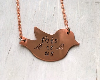 Hand stamped 'this is us' necklace on bird blank. Love wins.