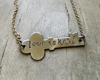 Love is key hand stamped necklace. Proceeds to Planned Parenthood. Inspirational. Love wins.