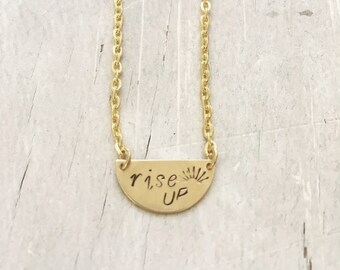 Hand stamped small half circle 'rise up' necklace. Proceeds to Planned Parenthood. Social change. Stronger together. Inspire.