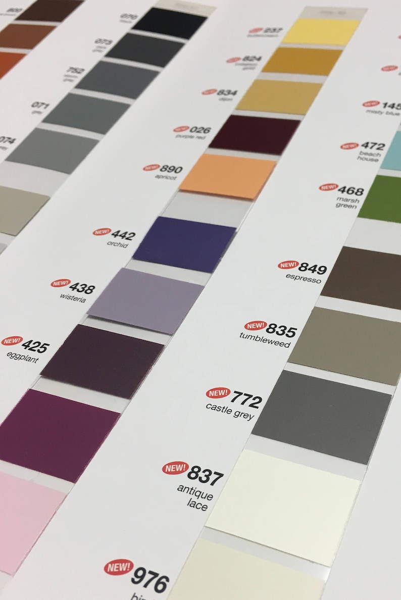 May include: Color swatches arranged diagonally, showcasing a variety of hues. The palette includes shades of gray, purple, orange, and brown, with labels indicating color names and numbers. Some swatches are marked with "NEW!"