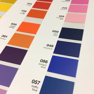 May include: A color chart with numbered color swatches in various shades of orange, red, pink, and blue. The chart includes color names like "pastel orange", "dark blue", and "brilliant blue". The swatches are arranged in vertical columns.
