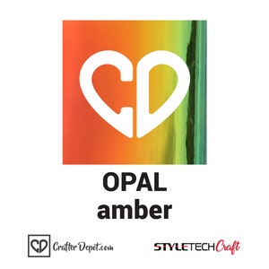 May include: A square sheet of opal amber vinyl with a white heart-shaped logo that says "CD" in the center. The vinyl has a gradient of orange, yellow, and green colors.
