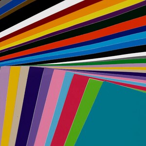 May include: A collection of colorful vinyl sheets arranged in a fan shape. The sheets are in various shades of blue, green, pink, red, yellow, and purple.