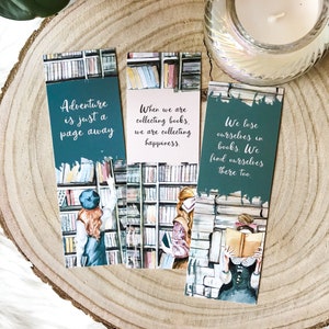 Puede incluir: Tres marcapáginas verde azulado con ilustraciones de acuarela de mujeres en una biblioteca. Los marcapáginas presentan citas sobre los libros y la lectura: "La aventura está a solo una página de distancia", "Cuando coleccionamos libros, coleccionamos felicidad" y "Nos perdemos en los libros. También nos encontramos allí."