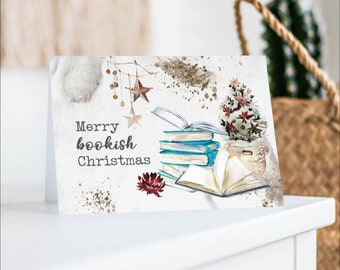 May include: A Christmas card with a watercolor illustration of a stack of books, a small potted Christmas tree, and the text "Merry bookish Christmas".
