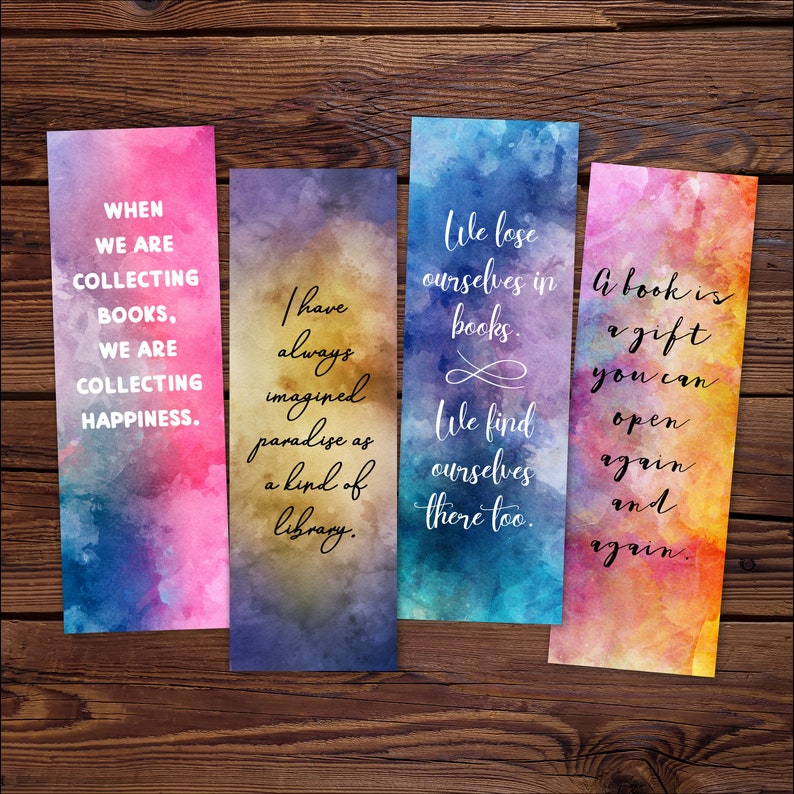 May include: Four colorful bookmarks with watercolor backgrounds and inspirational quotes about books and reading. The quotes are: "When we are collecting books, we are collecting happiness.", "I have always imagined paradise as a kind of library.", "We lose ourselves in books. We find ourselves there too.", and "A book is a gift you can open again and again."