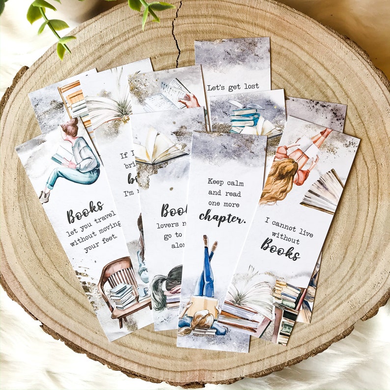 May include: Set of eight watercolor bookmarks featuring illustrations of books, people reading, and inspirational quotes. The quotes include "Let's get lost", "Books let you travel without moving your feet", "If I bring it, I'm reading it", "Book lovers never go to sleep alone", "Keep calm and read one more chapter", and "I cannot live without books".