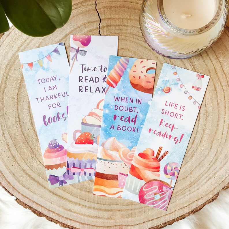 May include: Four colorful bookmarks with watercolor illustrations of cupcakes, donuts, and candy. The bookmarks feature inspirational quotes about reading, such as "Today, I am thankful for books!" and "Life is short. Keep reading!"