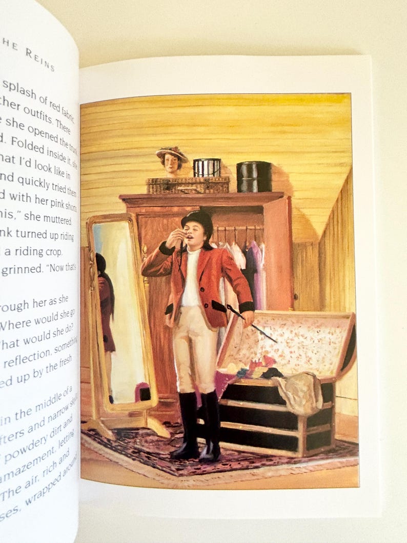 May include: An illustration from a book showing a person in a red riding jacket, white breeches, and black boots standing in a room. The person holds a riding crop near an open trunk and a tall mirror. A wooden wardrobe and a hat are visible nearby.