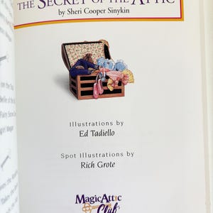 May include: The title page of the book The Secret of the Attic by Sheri Cooper Sinykin. It features an illustration of an open wooden chest filled with colorful clothing and accessories, with credits for Ed Tadiello, Rich Grote, and the Magic Attic Club.