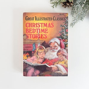 May include: A vintage hardcover book titled "Great Illustrated Classics Christmas Bedtime Stories." The cover features an illustration of Santa Claus reading to two children. The background shows a fireplace and a Christmas tree.