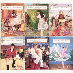 May include: A collection of six Magic Attic Club books featuring illustrated covers. Titles include The Secret of the Attic, Keisha's Maze Mystery, Keisha Leads the Way, Heather Takes the Reins, Heather Goes to Hollywood, and Heather at the Barre.