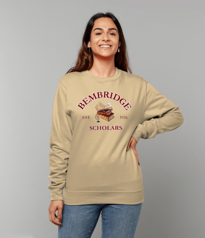 May include: A beige sweatshirt with a maroon graphic of a stack of books, a globe, and the text "Bembridge Scholars Est. 1926".