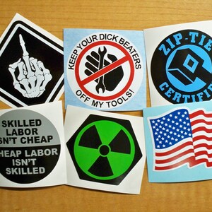 May include: A set of ten stickers with various designs. The stickers feature a black and white skeleton hand giving the middle finger, a red and white circle with the text "Keep Your Dick Beaters Off My Tools!" a black and blue circle with the text "Zip-Tie Certified", a black and white circle with the text "Skilled Labor Isn't Cheap, Cheap Labor Isn't Skilled", a green and black radiation symbol, and an American flag.