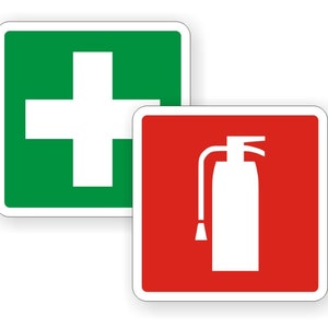 May include: Two square signs with white borders. The sign on the left is green with a white cross. The sign on the right is red with a white fire extinguisher.