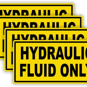 May include: Four yellow warning signs with black text that reads "HYDRAULIC FLUID ONLY".