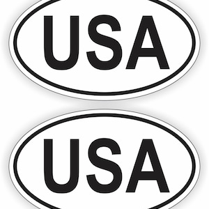 May include: Two white oval stickers with a black outline and the word "USA" printed in black.