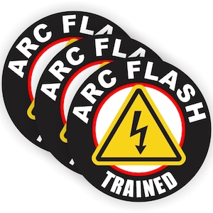 May include: Three black and white round stickers with the text "ARC FLASH TRAINED" in white letters with a red outline. The center sticker has a yellow triangle with a lightning bolt inside.