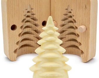 May include: A wooden mold for making butter sculptures in the shape of a Christmas tree. The mold is open and a finished butter sculpture is sitting in front of it.
