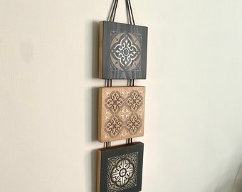 Long, narrow wall hanging in neutral colours