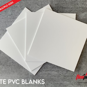 May include: Four white PVC blanks, available in multiple sizes. The blanks are square and are stacked on top of each other. The blanks are on a gray textured surface.