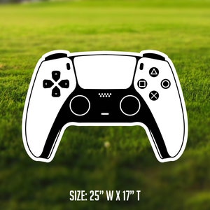 May include: A white and black outline of a video game controller. The controller has buttons and joysticks. The text "SIZE: 25" W X 17" T" is below the controller.