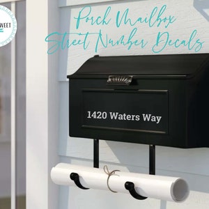 May include: Black mailbox with a white decal that says "1420 Waters Way" on a white house. The mailbox has a white paper roll holder attached to the bottom.