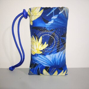 May include: A small blue drawstring bag with a floral pattern featuring yellow flowers and gold accents. The bag has a blue drawstring and a blue toggle.