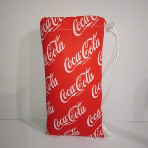 May include: Red drawstring bag with a white Coca-Cola logo pattern.