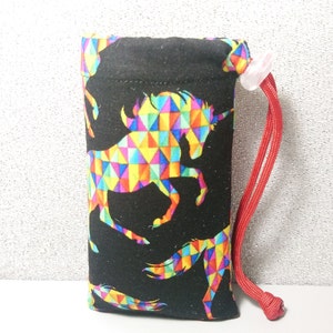 May include: A black drawstring bag with a colorful geometric unicorn pattern. The bag has a red drawstring.