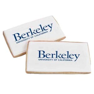 May include: Two rectangular cookies with white icing and the text "Berkeley UNIVERSITY OF CALIFORNIA" in blue. The cookies have a light brown, biscuit-like edge.