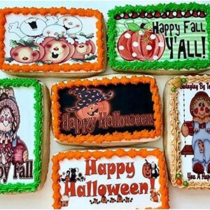 May include: A collection of decorated Halloween and fall-themed cookies. The cookies feature images of pumpkins, scarecrows, and the text "Happy Halloween" and "Happy Fall Y'all!" The cookies have orange, green, and tan frosting.