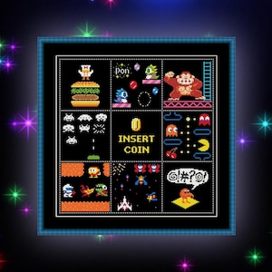May include: A framed cross-stitch featuring pixelated images of classic arcade games. The design includes characters and elements from games like Pac-Man, Donkey Kong, and Space Invaders, with the text "INSERT COIN". The background is black with colorful starbursts.